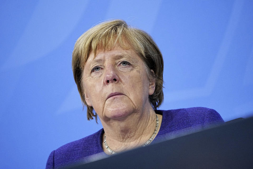 German Chancellor Angela Merkel meets the media during a news conference in Berlin, Thursday, Nov. 18, 2021. German lawmakers have approved new measures to rein in record coronavirus infections after the head of Germany’s disease control agency warned the country could face a “really terrible Christmas.” The measures passed in the Bundestag on Thursday includes requirements for employees to prove they are vaccinated, recovered from COVID-19 or have tested negative for the virus in order to access communal workplaces. (Michael Kappeler, Pool via AP)