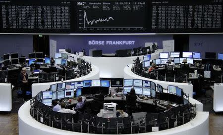 Traders are pictured at their desks in front of the DAX board at the Frankfurt stock exchange May 29, 2014. REUTERS/Remote/Stringer