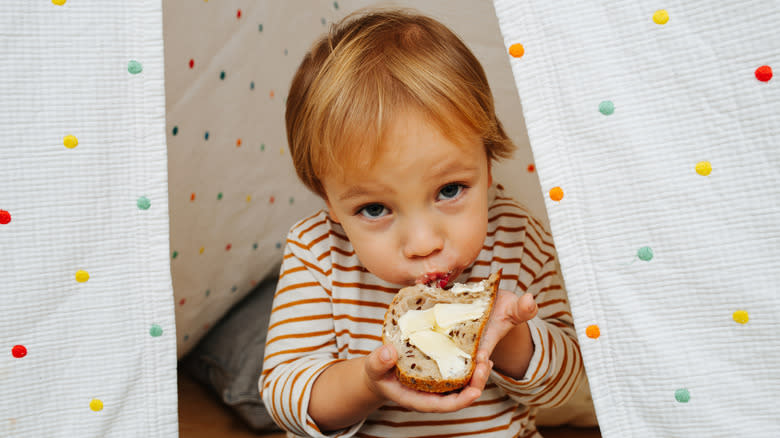 Boy eating butter on toast