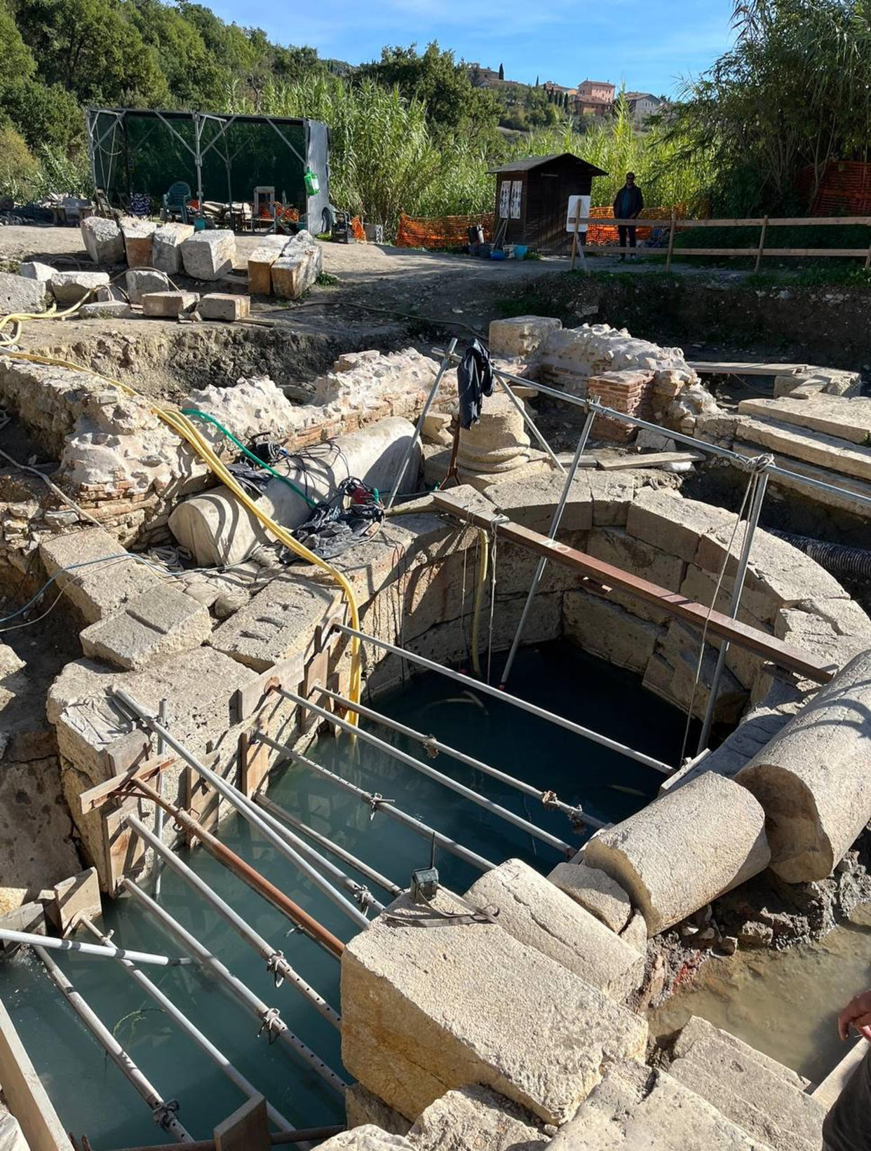 Archaeologists work at the site of the discovery of two dozen well-preserved bronze statues from an ancient Tuscan thermal spring in San Casciano dei Bagni, central Italy, in this update photo made available by the Italian Culture Ministry, Thursday, Nov. 3, 2022. (Italian Culture Ministry via AP)