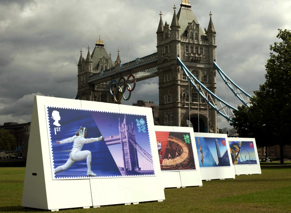 Enlarged images of Royal Mail's Welcome to the London 2012 Olympics stamps are displayed at Potters Fields, London on Monday July 23, 2012. The postal service says it will issue a stamp honoring every member of Team GB who wins a gold medal during the games. It is promising to have them on sale within 24 hours of the athlete's victory. (AP Photo/David Parry, PA)