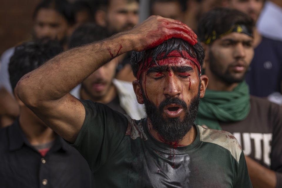 A Kashmiri Shiite Muslim mourns as he flagellates himself during a Muharram procession in Srinagar, Indian controlled Kashmir, Thursday, July 27, 2023. Muharram is a month of mourning for Shiite Muslims in remembrance of the martyrdom of Imam Hussein, the grandson of the Prophet Muhammad. (AP Photo/Dar Yasin)