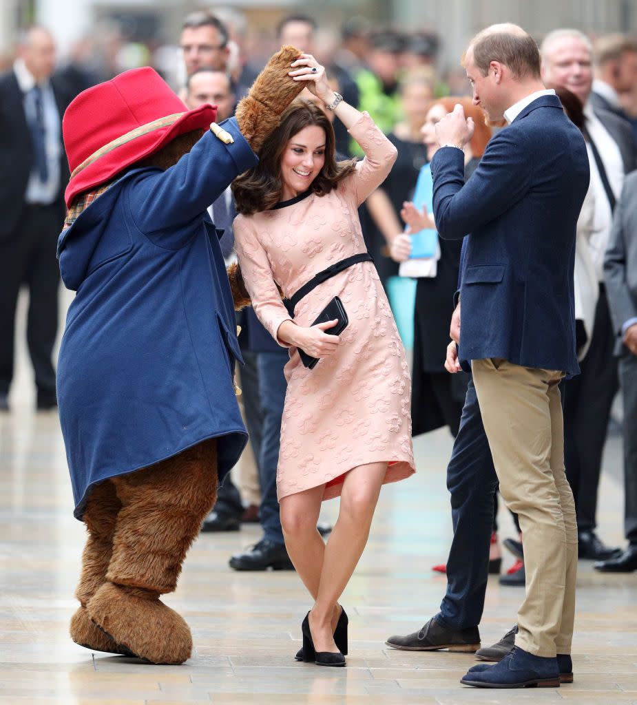 Kate Middleton dances with a giant bear.