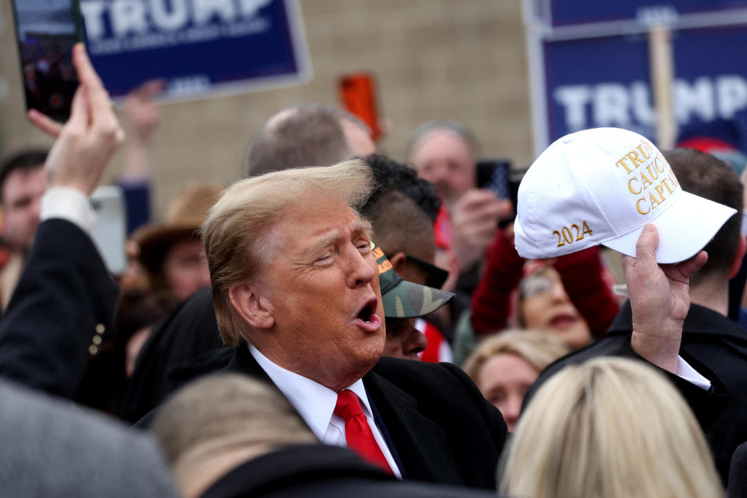 Donald Trump greets voters as he makes a visit to a polling station. 