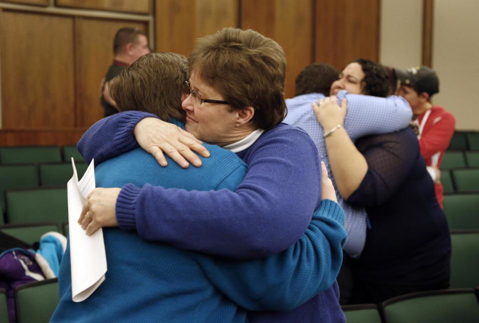 FILE - In this March 22, 2014 file photo Kat White, left, and Sue Walton hug after being married in a group ceremony by the Oakland County Clerk in Pontiac, Mich., after a federal judge has struck down Michigan's ban on gay marriage. Attorney General Eric Holder on Friday, March 28, 2014 extended federal recognition to the marriages of about 300 same-sex couples that took place in Michigan before a federal appeals court put those unions on hold. (AP Photo/Paul Sancya, File)