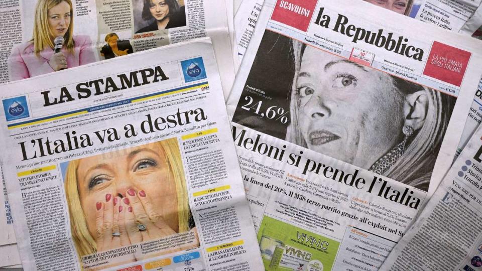 This photo taken in Rome on September 26, 2022, shows front pages of Italian newpapers with photos of leader of Italian far-right party 