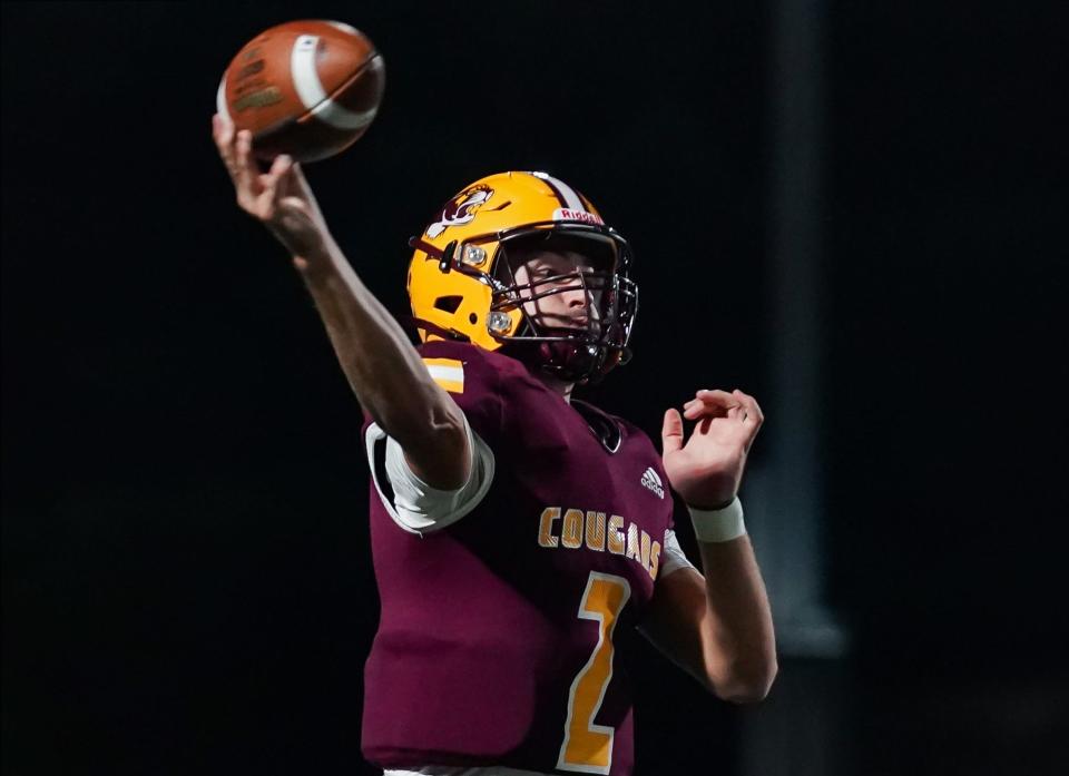 Bloomington North’s Dash King (2) throws a touchdown pass to Cole Grupenhoff during the football game against Columbus North at Bloomington North on Friday, Oct. 6, 2023.