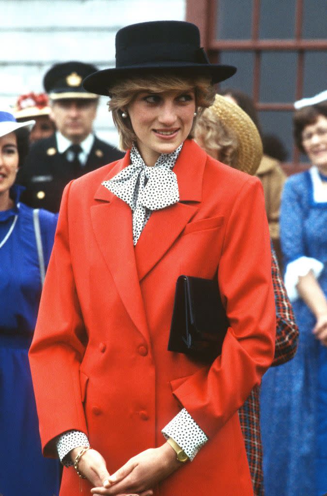 <p>This look was all about statement details: Princess Diana paired the bright red blazer with a polka dot blouse and a black hat. She wore this ensemble during a royal tour of Canada in June 1983.<br></p>