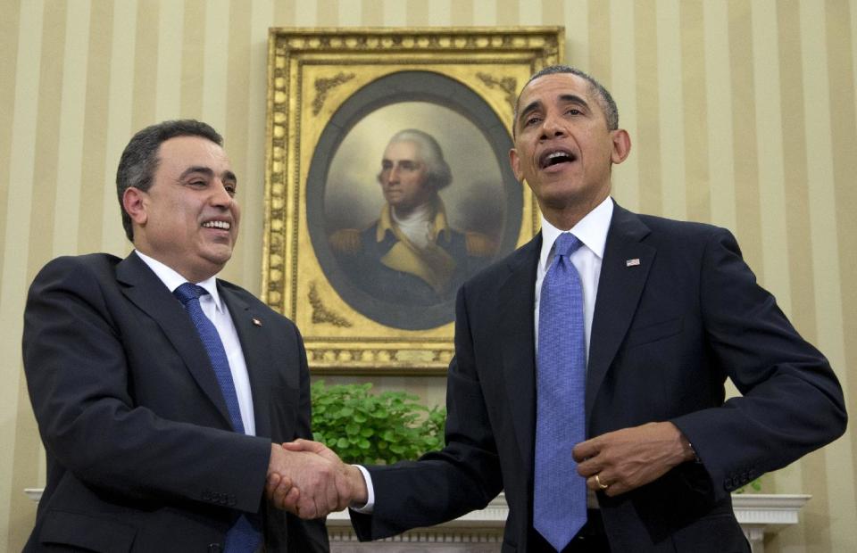 President Barack Obama and Tunisian Prime Minister Mehdi Jomaa shakes hands after speaking to the media, Friday, April 4, 2014, in the Oval Office of the White House in Washington. (AP Photo/Carolyn Kaster)