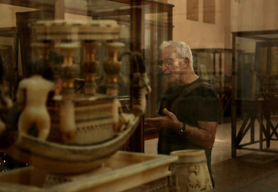 In this Wednesday, Oct. 30, 2013 photo, a tourist visits the Egyptian Museum near Tahrir Square in Cairo, Egypt. The 111-year-old museum, a treasure trove of pharaonic antiquities, has long been one of the centerpieces of tourism to Egypt. But the constant instability since the 2011 uprising that toppled autocrat Hosni Mubarak has dried up tourism to the country, slashing a key source of revenue. Moreover, political backbiting and attempts to stop corruption have had a knock-on effect of bringing a de facto ban on sending antiquities on tours to museums abroad, cutting off what was once a major source of funding for the museum. (AP Photo/Nariman El-Mofty)