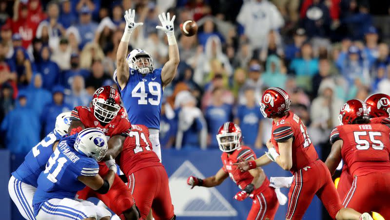 BYU Cougars linebacker Payton Wilgar (49) knocks down a pass by Utah Utes quarterback Charlie Brewer (12) as BYU and Utah play an NCAA football game at LaVell Edwards Stadium in Provo on Sept. 11, 2021. BYU won 27-16 ending a nine-game losing streak to the Utes.