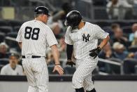 New York Yankees third base coach Phil Nevin, left, celebrates with Gary Sanchez, right, as Sanchez runs the bases after hitting a home run during the second inning of a baseball game against the Texas Rangers, Monday, Sept. 20, 2021, in New York. (AP Photo/Frank Franklin II)