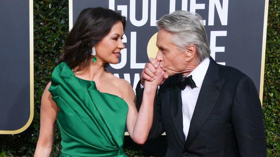 Michael Douglas kissing Catherine Zeta Jones's hand 