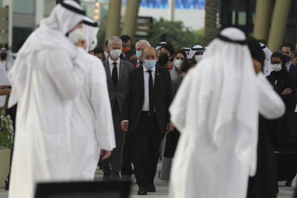 French Foreign Affairs Minister Jean-Yves Le Drian, centre, arrives for an official ceremony at Al Wasl Plaza at the Dubai Expo 2020 in Dubai, United Arab Emirates, Saturday, Oct. 2, 2021. (AP Photo/Kamran Jebreili)