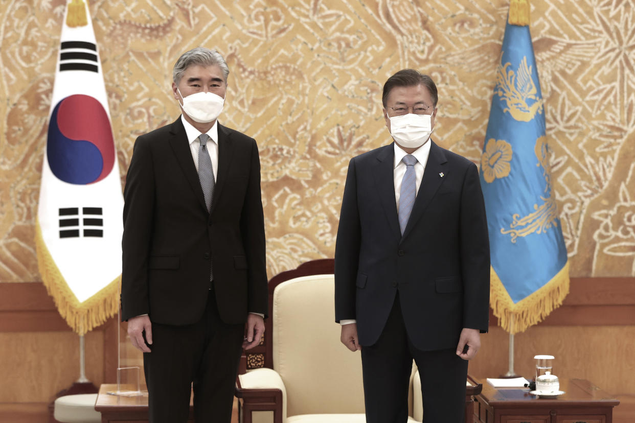 South Korean President Moon Jae-in, right, and U.S. Special Representative for North Korea, Sung Kim, pose for photos prior to their meeting at the presidential Blue House in Seoul, South Korea, Tuesday, June 22, 2021. Kim Yo Jong, the powerful sister of North Korean leader Kim Jong Un, dismissed prospects for early resumption of diplomacy with the United States, saying Tuesday the U.S. expectations for talks would "plunge them into a greater disappointment. (Choe Jae-koo/Yonhap via AP)