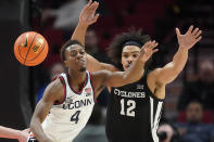 Connecticut guard Nahiem Alleyne (4) and Iowa State forward Robert Jones (12) watch the ball during the first half of an NCAA college basketball game for the championship of the Phil Knight Invitational on Sunday, Nov. 27, 2022, in Portland, Ore. (AP Photo/Rick Bowmer)