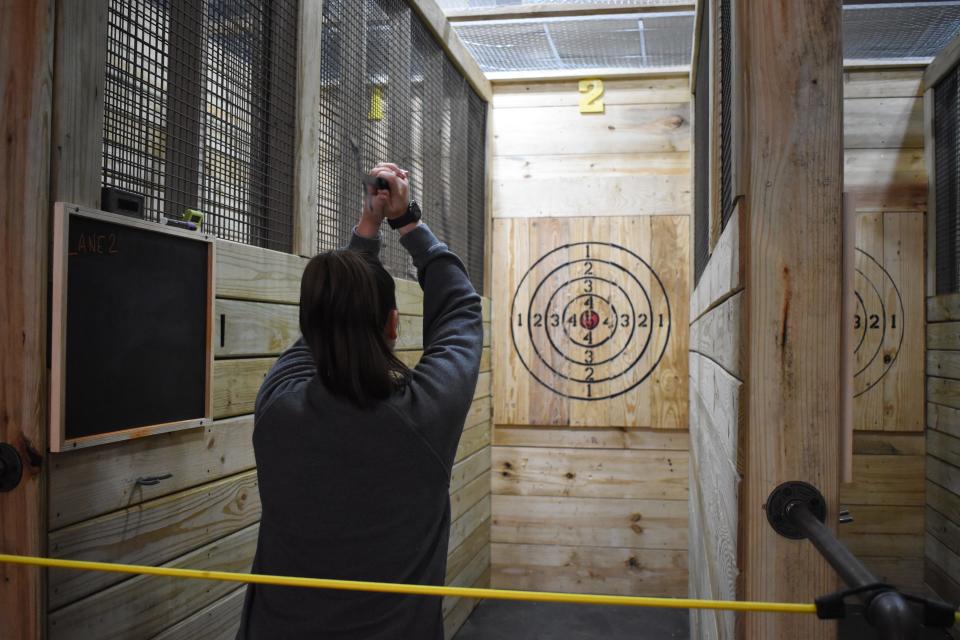 Paula Hines prepares to throw an ax at Lancaster Axes, located on N. Columbus Street.