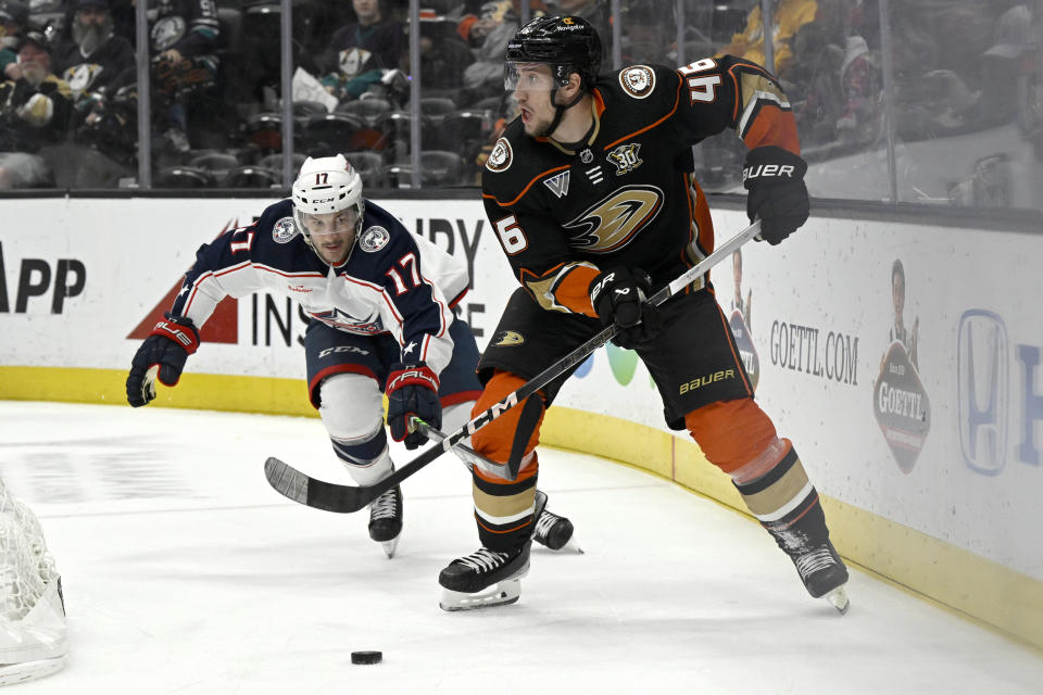 Anaheim Ducks defenseman Ilya Lyubushkin (46) controls the puck with Columbus Blue Jackets right wing Justin Danforth (17) defending during the first period of an NHL hockey game in Anaheim, Calif., Wednesday, Feb. 21, 2024. (AP Photo/Alex Gallardo)