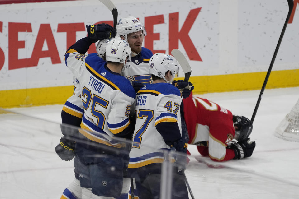 St. Louis Blues center Jordan Kyrou (25) is congratulated by his teammates after scoring a goal during the second period of an NHL hockey game against the Florida Panthers, Thursday, Dec. 21, 2023, in Sunrise, Fla. (AP Photo/Marta Lavandier)