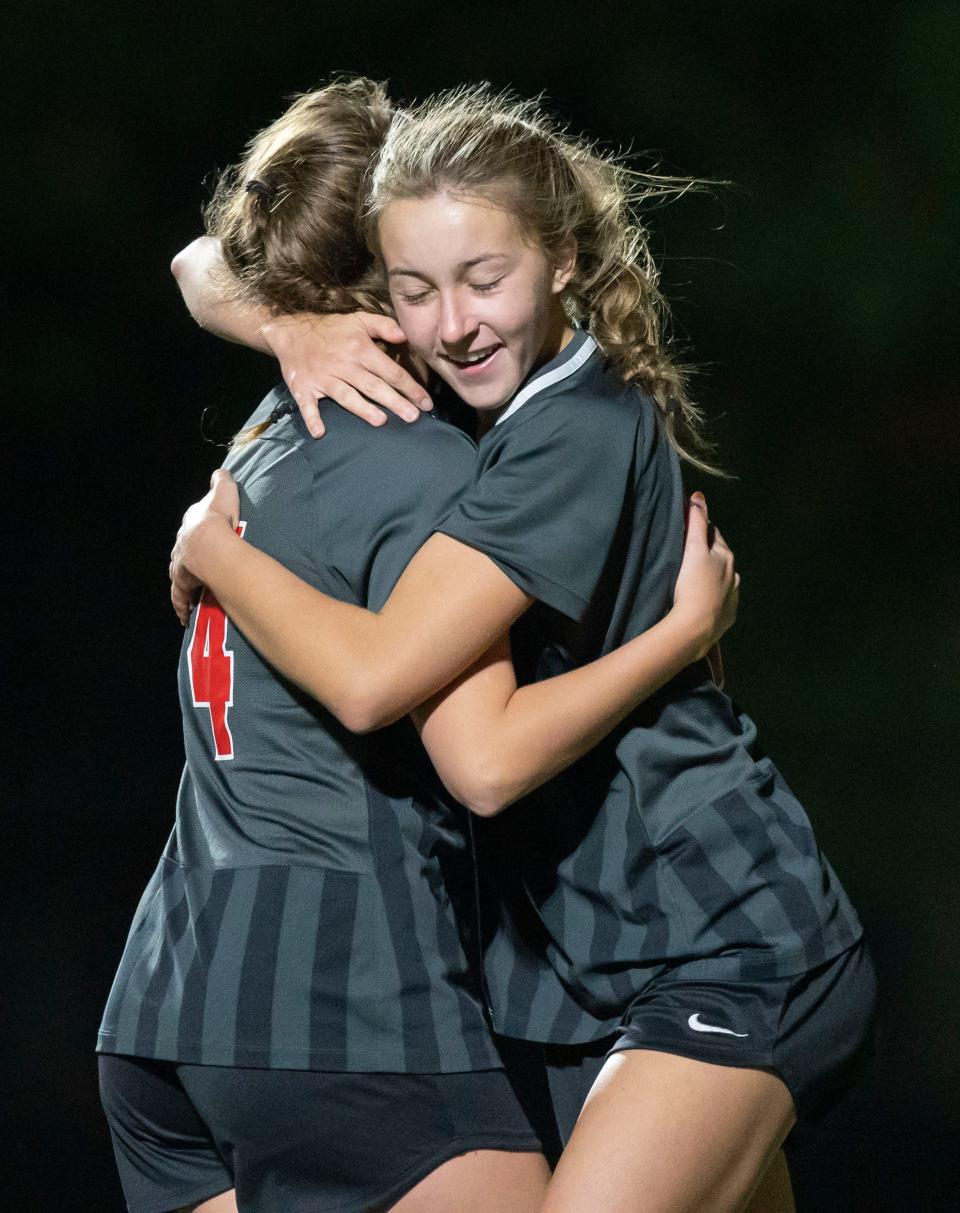 Center Grove Trojans midfielder Taylor Wert, right, and Center Grove Trojans defender Addie Crowe celebrate a goal Thursday, Oct. 13, 2022, at Center Grove High School. 