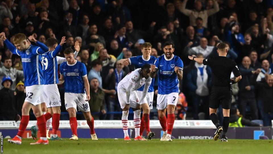 Portsmouth players celebrate beating Barnsley as they clinch promotion to the Championship