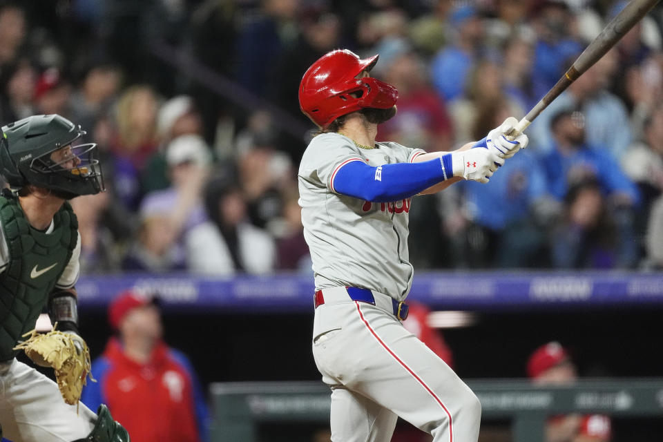 Philadelphia Phillies' Bryce Harper watches his three-run home run off Colorado Rockies relief pitcher John Curtiss during the ninth inning of a baseball game Saturday, May 25, 2024, in Denver. (AP Photo/David Zalubowski)z