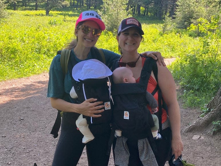 Women posing with babies during a hike