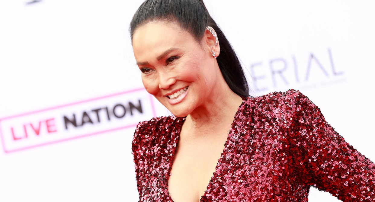 Tia Carrere went for a bold red hot to celebrate the Grammys. (Image via Getty Images)