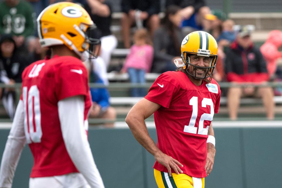 Aaron Rodgers (12) smiles at quarterback Jordan Love during training camp.