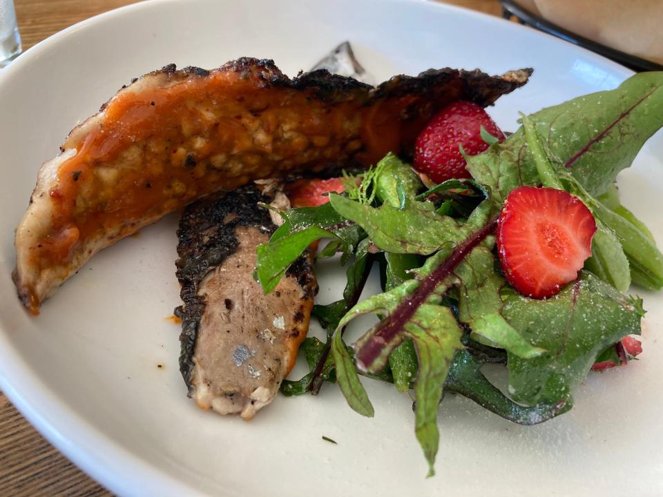 Barbecued mackerel with rhubarb chili sauce, strawberries, sugar-snap peas and dandelion greens, shown June 24, 2022 at May Day in Burlington.