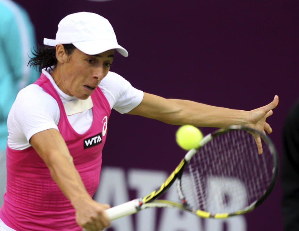 Francesca Schiavone of Italy returns the ball to Magdalena Rybarikova of Slovakia during the second day of the WTA Qatar Ladies Open in Doha, Qatar, Tuesday, Feb. 11, 2014. (AP Photo/Osama Faisal)