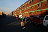 A man walks outside Jeppestown men's hostel in Johannesburg May 19, 2015. REUTERS/Siphiwe Sibeko