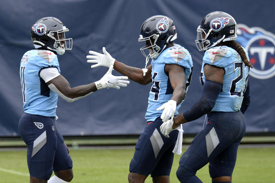 Tennessee Titans wide receiver A.J. Brown (11) is congratulated by Corey Davis (84) and Derrick Henry (22) after Brown scored a touchdown on a 73-yard pass reception against the Pittsburgh Steelers in the second half of an NFL football game Sunday, Oct. 25, 2020, in Nashville, Tenn. (AP Photo/Mark Zaleski)