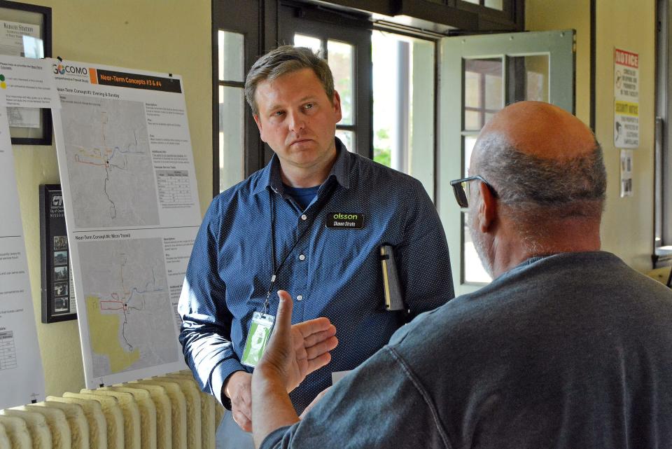 Shawn Strate, Olsson Assocates senior transportation planner, listens to a member of the public Tuesday during a meeting at Wabash Bus Station on the city's comprehensive transit study.