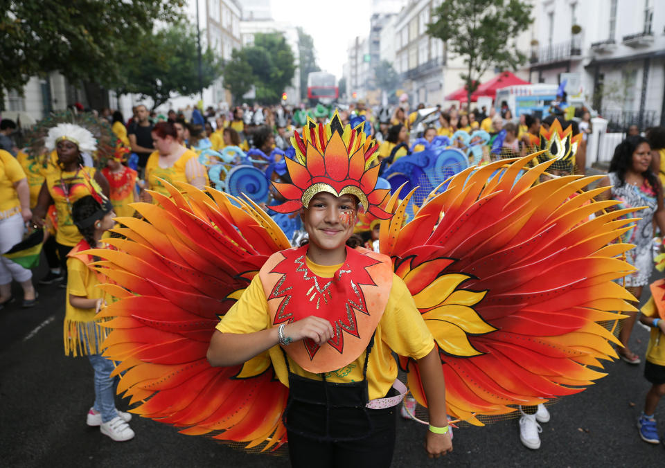 <p>Performers in costume parade on the first day of the Notting Hill Carnival in west London on August 28, 2016. (Photo: DANIEL LEAL-OLIVAS/AFP/Getty Images) </p>