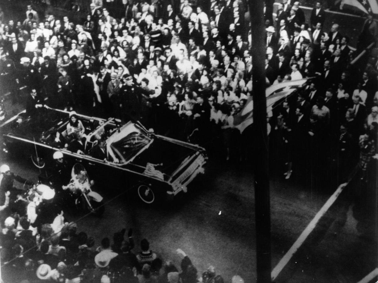 22nd November 1963: US statesman John F Kennedy, 35th president of the US, and his wife Jackie Kennedy travelling in the presidential motorcade at Dallas, before his assassination: Getty