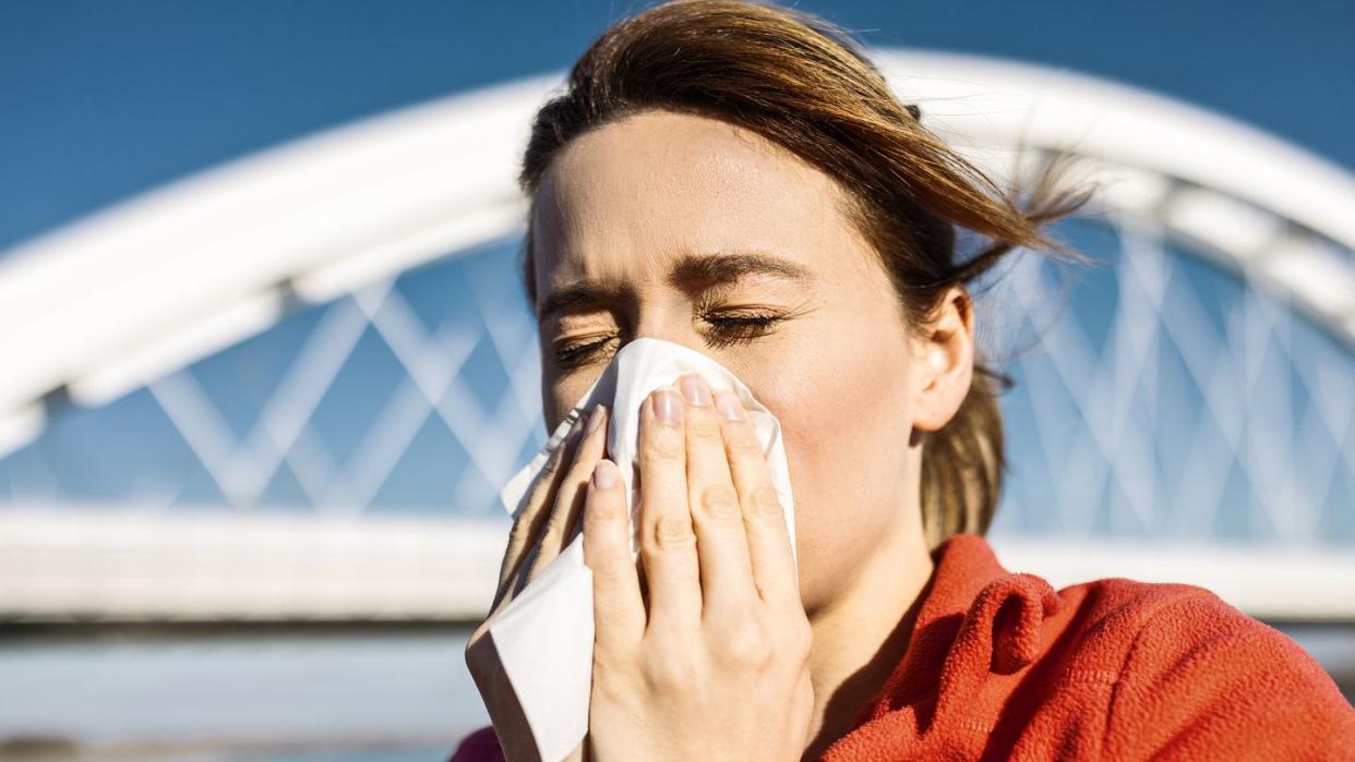 sporty woman sneezes during jog