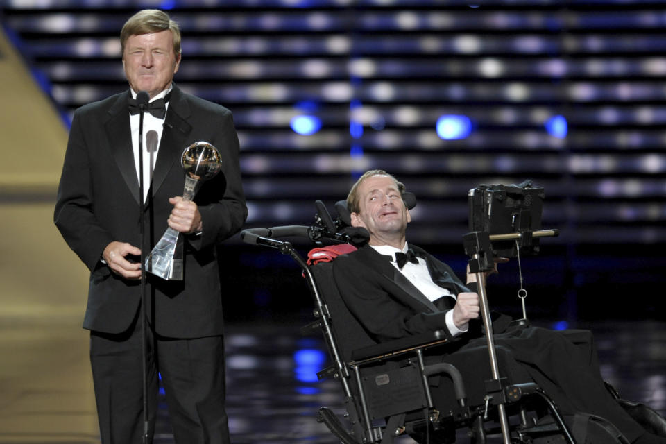 FILE - In this July 17, 2013, file photo, Dick Hoyt, left, and Rick Hoyt, accept the Jimmy V Perseverance Award at the ESPY Awards at the Nokia Theater in Los Angeles. Dick Hoyt, who last competed with his son in the Boston Marathon in 2014, has died, the Boston Athletic Association announced Wednesday, March 17, 2021. He was 80. (Photo by John Shearer/Invision/AP, File)