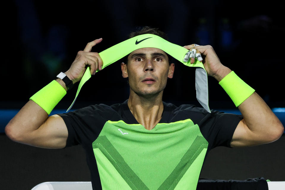 Rafael Nadal (pictured) does his headband up.