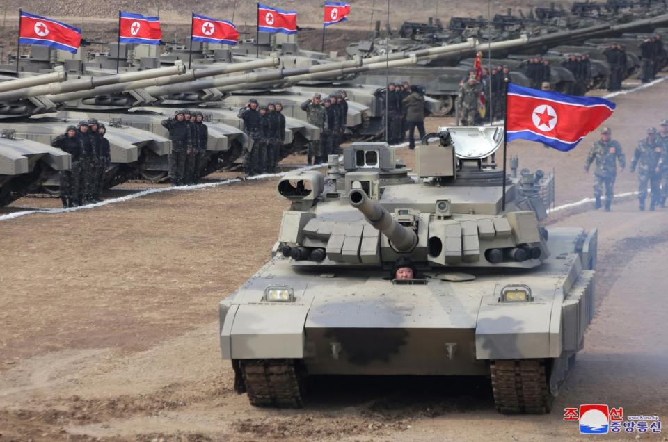 North Korean Supreme leader Kim Jong Un drives new-type tank during drills (EPA)