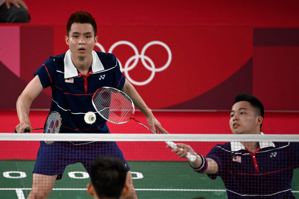 Malaysia’s Aaron Chia hits a shot next to Soh Wooi Yik in their men’s doubles badminton semi-final match against China’s Liu Yuchen and Li Junhui at the Musashino Forest Sports Plaza in Tokyo July 30, 2021. — AFP pic