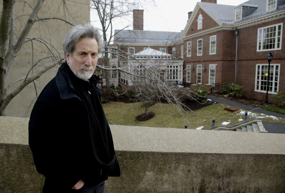 In this Monday, Jan. 27, 2014 photo, film professor Robb Moss, who has taught for twenty-five years at Harvard, stands outside the Carpenter Center for the Visual Arts on the school's campus in Cambridge, Mass, Mass. Three filmmakers nominated separately for this year’s Oscar for best feature documentary credit Moss for inspiring them to greatness. (AP Photo/Stephan Savoia)