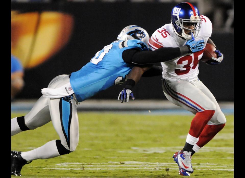 New York Giants running back Andre Brown (35) rushes through a tackle from Carolina Panthers linebacker James Anderson (50) during the first quarter of an NFL football game in Charlotte, N.C., Thursday, Sept. 20, 2012.