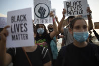 Protesters hold signs and shout slogans during a protest to decry the killing of George Floyd in front of the American embassy in Tel Aviv, Israel, Tuesday, June 2, 2020. (AP Photo/Ariel Schalit)
