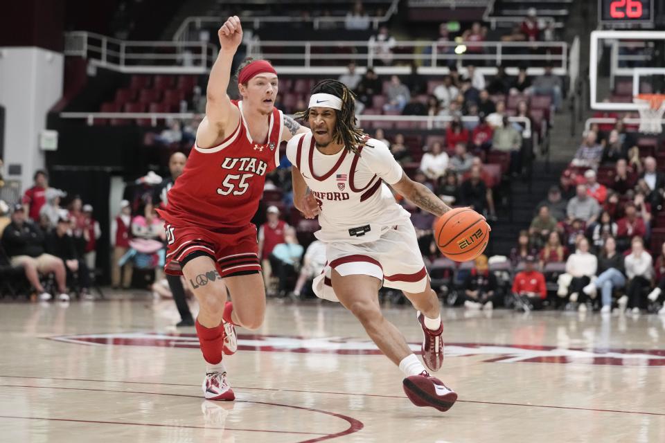 Stanford guard Kanaan Carlyle (3) dribbles past Utah guard Gabe Madsen (55) during the second half of an NCAA college basketball game, Sunday, Jan. 14, 2024, in Stanford, Calif. | Godofredo A. Vásquez, Associated Press