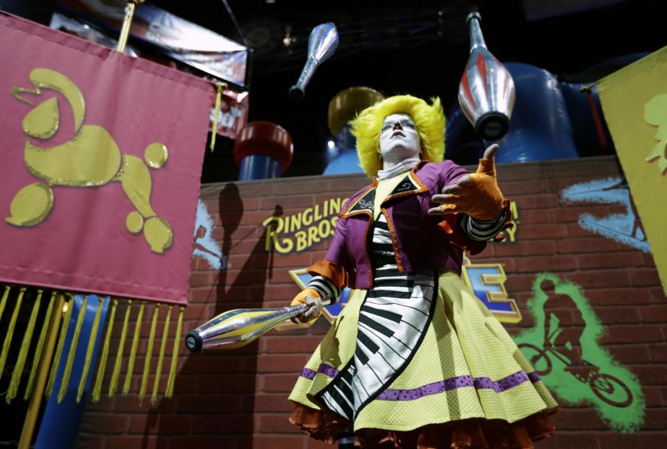 A Ringling Bros. and Barnum & Bailey clown juggles for fans during a pre show for fans Saturday, Jan. 14, 2017, in Orlando, Fla. The Ringling Bros. and Barnum & Bailey Circus will end the "The Greatest Show on Earth" in May, following a 146-year run of performances. Kenneth Feld, the chairman and CEO of Feld Entertainment, which owns the circus, told The Associated Press, declining attendance combined with high operating costs are among the reasons for closing. (AP Photo/Chris O'Meara)