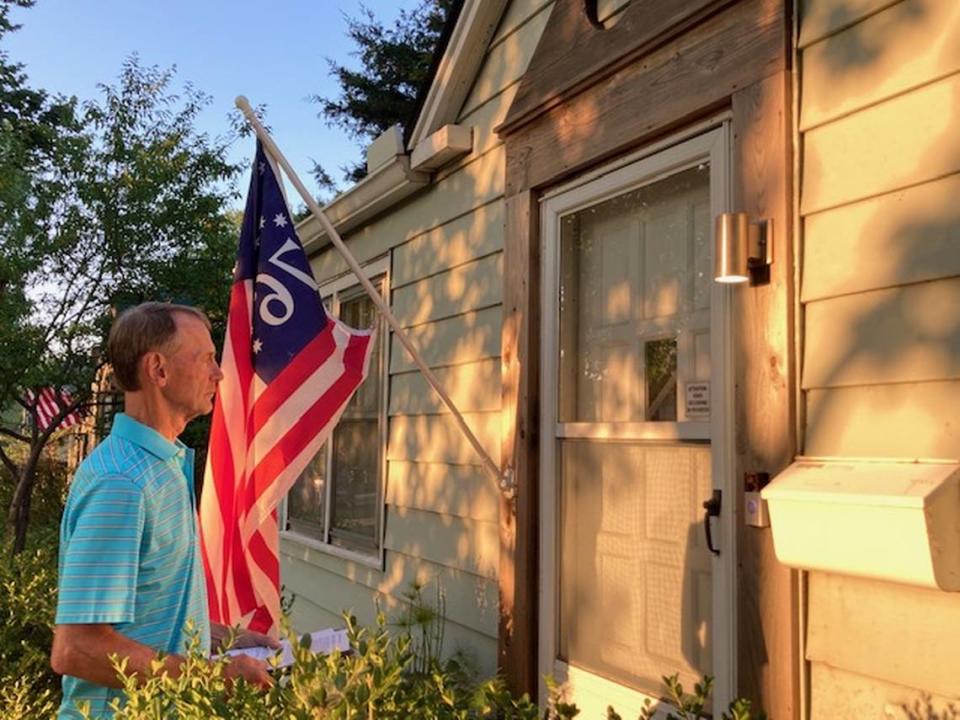 Mike Coffman of Westwood Hills knocks on doors in neighboring Westwood to drum up support for a protest against a proposed office and retail development at 50th Street and Rainbow Boulevard.