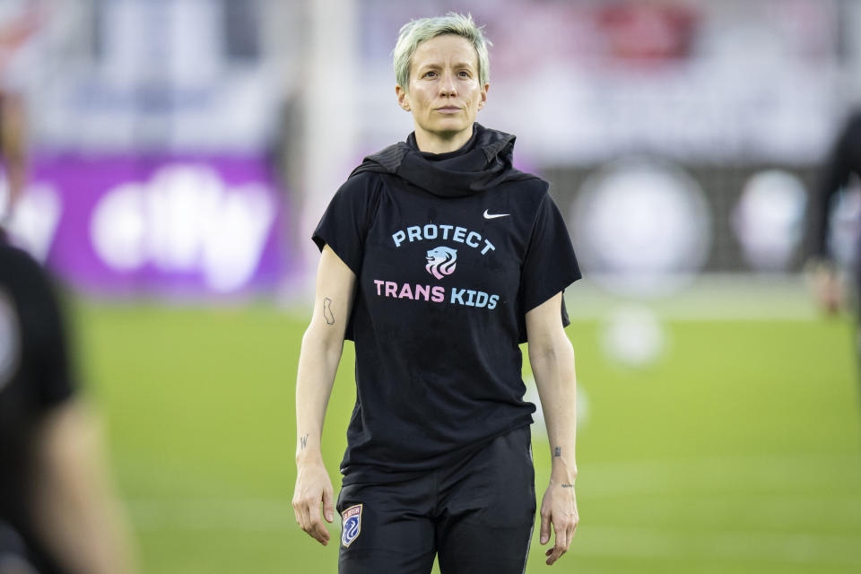 Football star Megan Rapinoe (pictured) wears a shirt that says Protest Trans Kids while warming up.