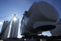 Generators, right, and towers for offshore wind turbines sit at State Pier in New London, Conn., Monday, Dec. 4, 2023. (AP Photo/Seth Wenig)