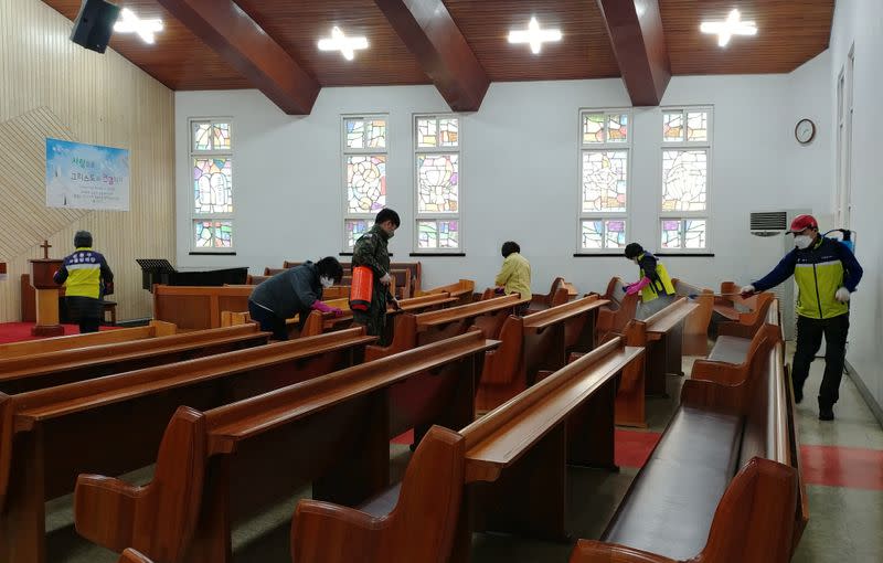 Residents sanitize at a church in Seoul